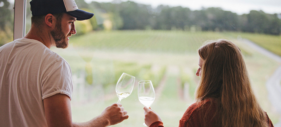 A man and a woman wine tasting